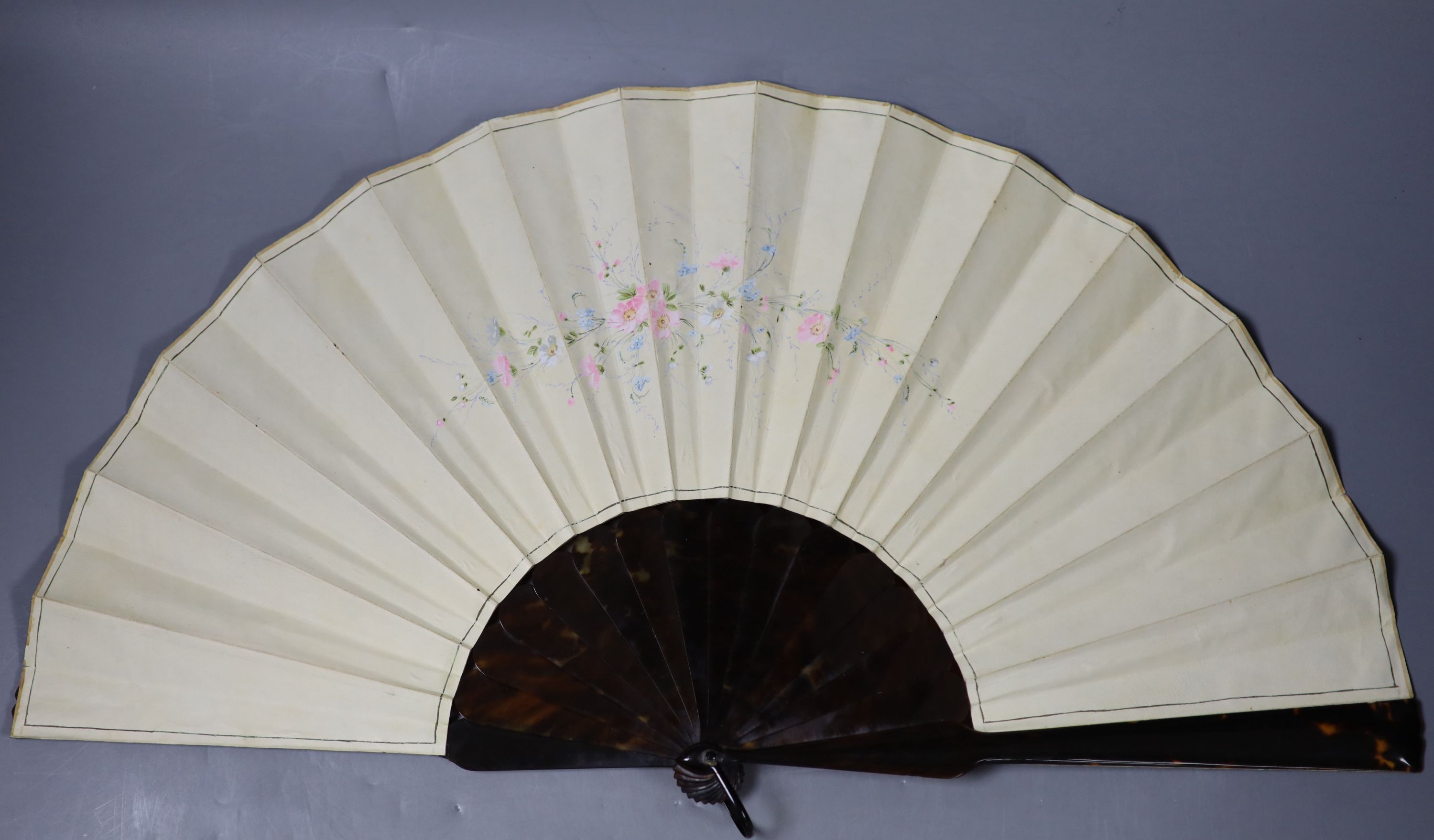 A late 19th century French painted vellum and tortoishell fan, 29.5cm and another